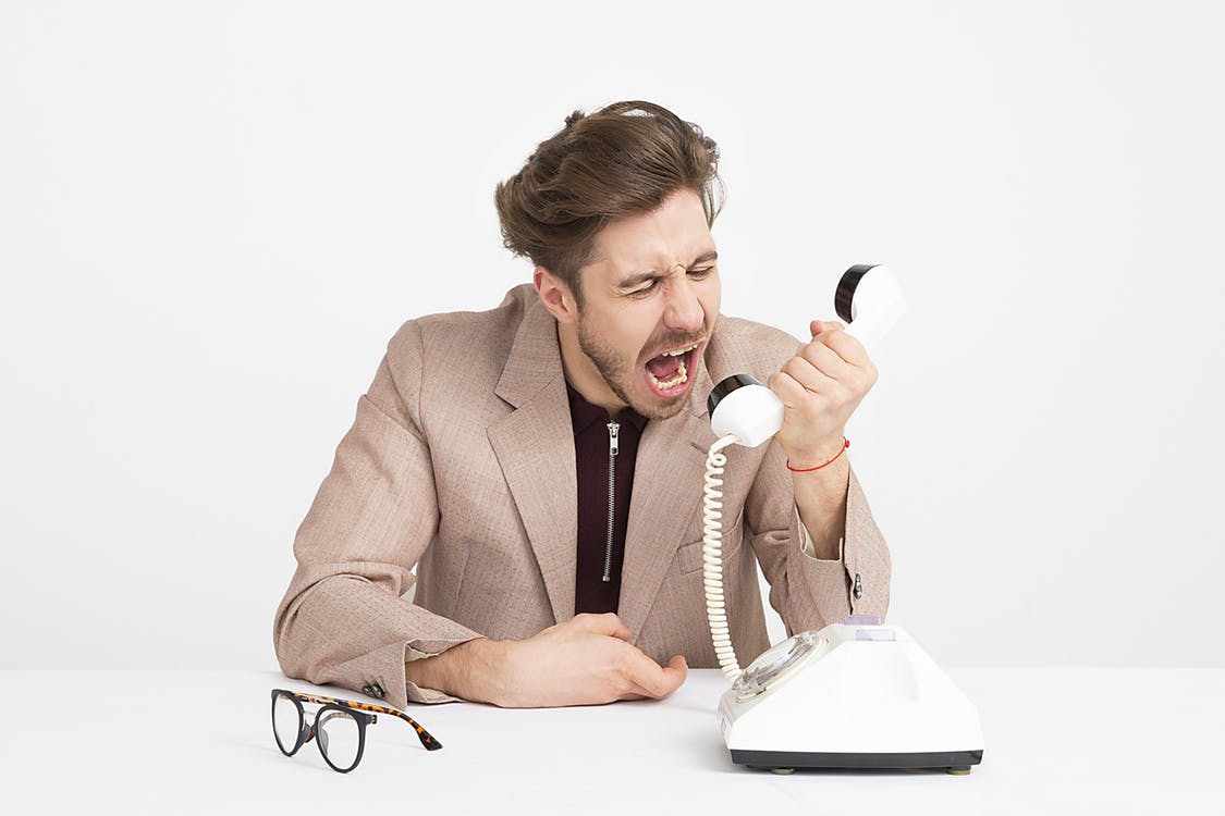 Angry person yelling over the phone